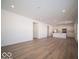 Open living room with kitchen and island views, hardwood floors at 6196 Granby Dr, Whitestown, IN 46075