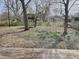 View from the window of the fenced backyard and wooden play structure at 927 Stockton St, Indianapolis, IN 46260