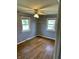 Cozy bedroom featuring hardwood floors, two windows and a ceiling fan at 927 Stockton St, Indianapolis, IN 46260