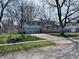 Two-story home with a large driveway, garage, and landscaped front yard at 927 Stockton St, Indianapolis, IN 46260