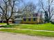 Charming two-story home with a well-manicured lawn and beautiful flowers at 927 Stockton St, Indianapolis, IN 46260