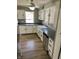 Bright kitchen featuring white cabinets, stainless steel appliances, and hardwood floors at 927 Stockton St, Indianapolis, IN 46260