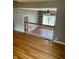 View of open living room with hardwood floors, staircase, and shelving at 927 Stockton St, Indianapolis, IN 46260