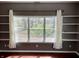Bright living room featuring built-in shelves and a large window with a view at 927 Stockton St, Indianapolis, IN 46260