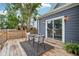 Back deck with wood floors, modern furniture, access to the backyard, and outdoor lighting at 560 Jefferson Ave, Indianapolis, IN 46201
