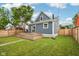 Spacious backyard with a wooden deck, a grassy lawn, and privacy fencing at 560 Jefferson Ave, Indianapolis, IN 46201