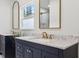 A bright bathroom with double sink vanities, granite countertops, and framed mirrors at 560 Jefferson Ave, Indianapolis, IN 46201
