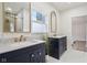 A bright bathroom with double sink vanities, granite countertops, and framed mirrors at 560 Jefferson Ave, Indianapolis, IN 46201