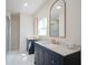Bathroom with double vanity, gold fixtures, and marble tile at 560 Jefferson Ave, Indianapolis, IN 46201