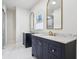 A bright bathroom with double sink vanities, granite countertops, and framed mirrors at 560 Jefferson Ave, Indianapolis, IN 46201