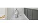 Bathroom with a toilet, marble tile flooring, and stylish wainscoting at 560 Jefferson Ave, Indianapolis, IN 46201