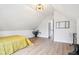 Bedroom with vaulted ceilings, modern lighting, neutral decor and wood-look floors at 560 Jefferson Ave, Indianapolis, IN 46201