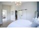 Main bedroom with sliding barn door and view of dining area at 560 Jefferson Ave, Indianapolis, IN 46201