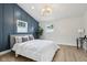 A primary bedroom featuring a decorative wall, wood flooring, and a modern chandelier at 560 Jefferson Ave, Indianapolis, IN 46201