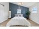 This primary bedroom boasts a decorative chandelier and a modern accent wall at 560 Jefferson Ave, Indianapolis, IN 46201