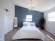 Spacious bedroom with a blue accent wall and chandelier at 560 Jefferson Ave, Indianapolis, IN 46201