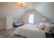 Bedroom with white bedding, light gray couch, and a window at 560 Jefferson Ave, Indianapolis, IN 46201
