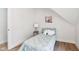 Cozy bedroom with a side table, a twin bed, and a painting on the wall at 560 Jefferson Ave, Indianapolis, IN 46201