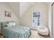 Charming bedroom with a pitched roof, a unicorn beanbag, and a window view at 560 Jefferson Ave, Indianapolis, IN 46201