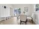 Charming breakfast nook with a round table, white chairs, and sliding doors to the outdoor deck, bathed in natural light at 560 Jefferson Ave, Indianapolis, IN 46201