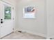 Entryway showcasing a decorative glass front door, hexagon tiled floors, and a window allowing natural light at 560 Jefferson Ave, Indianapolis, IN 46201