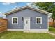 Exterior view of the house featuring a welcoming door flanked by two windows and sconces at 560 Jefferson Ave, Indianapolis, IN 46201