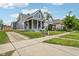 Exterior view of gray home with a front porch, steps, and a nearby sidewalk at 560 Jefferson Ave, Indianapolis, IN 46201
