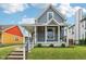 Charming two-story home with a covered front porch and landscaped front yard offering lovely curb appeal at 560 Jefferson Ave, Indianapolis, IN 46201