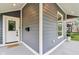 Exterior view showcasing the home's front porch with a decorative welcome mat and sleek black mailbox at 560 Jefferson Ave, Indianapolis, IN 46201