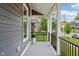 Exterior shot of a covered front porch area with dark rails and supports at 560 Jefferson Ave, Indianapolis, IN 46201