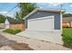 Attached garage with an expansive concrete driveway for ample parking at 560 Jefferson Ave, Indianapolis, IN 46201