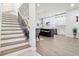 View of the kitchen with stainless appliances, white cabinets, and wooden stair steps at 560 Jefferson Ave, Indianapolis, IN 46201