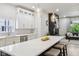 Modern kitchen featuring a large island, white cabinets, stainless steel appliances, and seamless flow to the living area at 560 Jefferson Ave, Indianapolis, IN 46201
