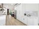 Bright and modern kitchen features stainless steel refrigerator, island with blue base, and contemporary design throughout at 560 Jefferson Ave, Indianapolis, IN 46201