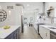 Contemporary kitchen with stainless steel appliances, open shelving, and island with seating, leading to a bright dining area at 560 Jefferson Ave, Indianapolis, IN 46201