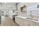 Bright kitchen with stainless steel range and hood, white cabinetry, light countertops, and stylish tiled backsplash at 560 Jefferson Ave, Indianapolis, IN 46201