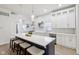 Bright, open kitchen featuring a large island with seating, stainless steel appliances, and stylish pendant lighting at 560 Jefferson Ave, Indianapolis, IN 46201
