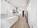 Spacious kitchen with stainless steel appliances, white cabinetry, and light wood floors, offering a modern design at 560 Jefferson Ave, Indianapolis, IN 46201