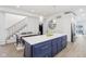 Open-concept kitchen featuring a large island, modern pendant lights, and a view of the staircase and dining area at 560 Jefferson Ave, Indianapolis, IN 46201