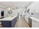 Modern kitchen boasts a large island, stainless steel appliances, light wood floors, and access to a dining area at 560 Jefferson Ave, Indianapolis, IN 46201