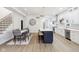 Open-concept living space combining a dining area, kitchen island, and staircase, ideal for modern living at 560 Jefferson Ave, Indianapolis, IN 46201