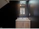 Powder room with dark walls, gold mirror, and light vanity at 560 Jefferson Ave, Indianapolis, IN 46201