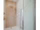 Walk-in shower with wood-look tile and gold fixtures at 560 Jefferson Ave, Indianapolis, IN 46201