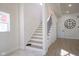 Modern staircase with light wood steps and dark metal railing at 560 Jefferson Ave, Indianapolis, IN 46201