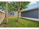 Backyard featuring a view of the house with a wooden deck, lawn, and tree at 560 Jefferson Ave, Indianapolis, IN 46201