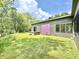 Exterior view of the home with a hot tub in the backyard and trees in the distance at 7650 Clarion Dr, Indianapolis, IN 46236