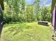 Expansive backyard featuring a lush lawn, mature trees, and a relaxing hot tub at 7650 Clarion Dr, Indianapolis, IN 46236