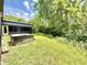 Well-maintained backyard with a hot tub and abundant trees, providing a serene outdoor space at 7650 Clarion Dr, Indianapolis, IN 46236