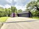 Modern home with a large driveway, two-car garage, and unique color accents at 7650 Clarion Dr, Indianapolis, IN 46236