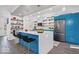 Bright kitchen with a center island, stainless steel appliances and attractive blue cabinets and gold hardware at 7650 Clarion Dr, Indianapolis, IN 46236